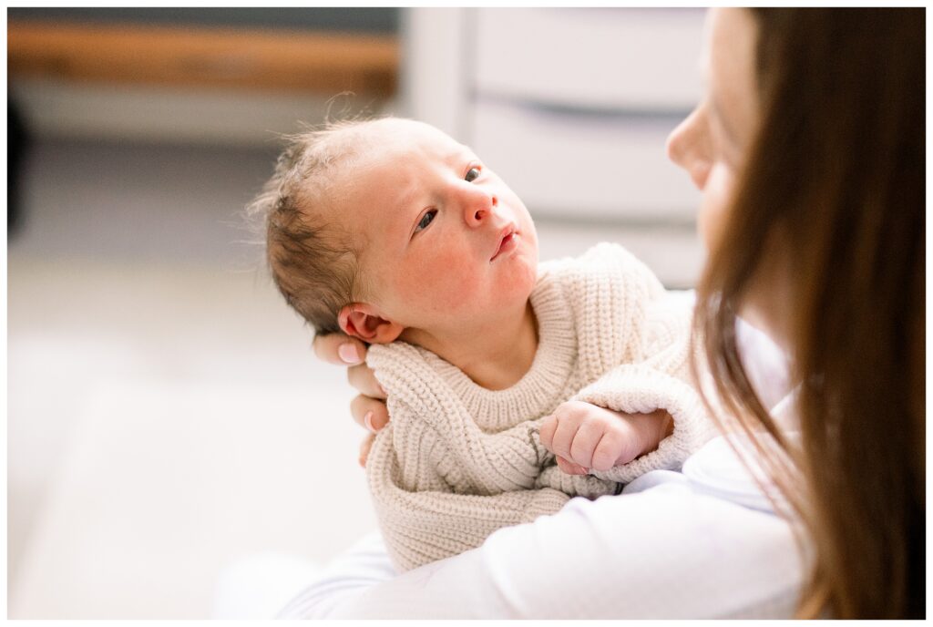 Mom holding her brand new baby boy just 24 hours old in the hospital after delivery at Morristown Medical Center during baby's first photo shoot with Fresh 48 Newborn Photographer renee Ash Photography