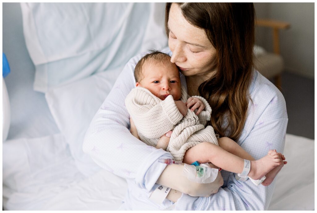 Mom holding a Baby boy in the hospital after delivery at Morristown Medical Center during baby's first photo shoot with Fresh 48 Newborn Photographer renee Ash Photography