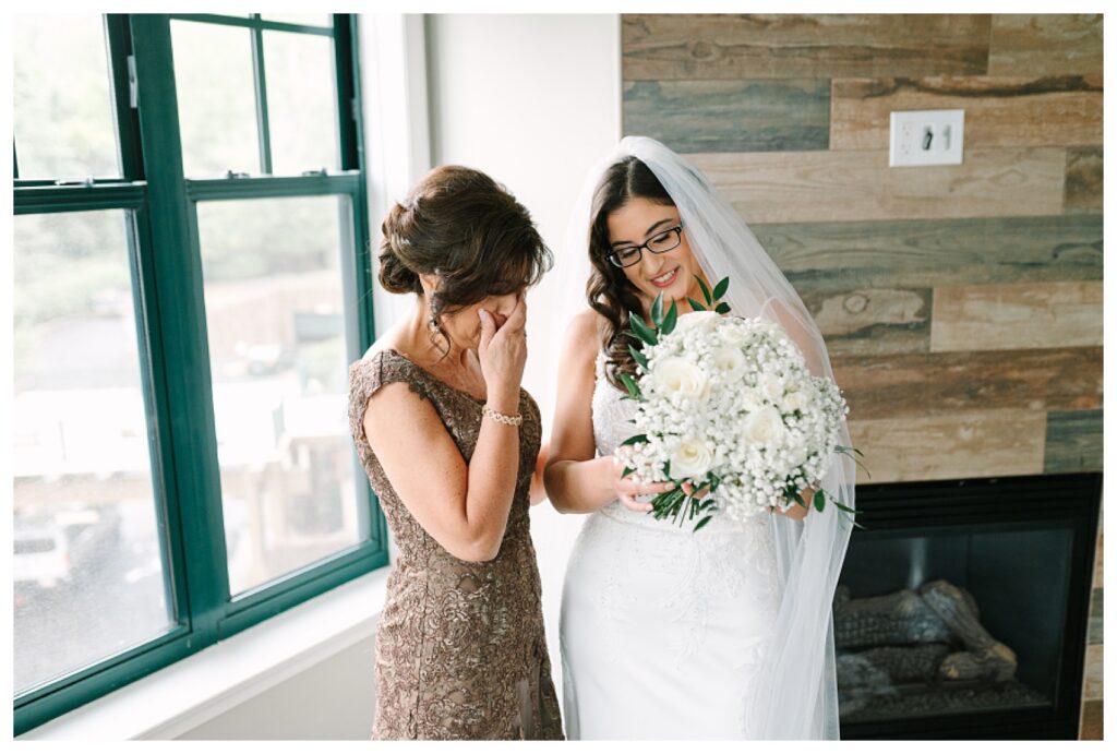 Mother daughter emotional moment showing the bouquet charms with loved ones who have passed away  : Wedding at Mountain Creek Resort Venue Photographer Renee Ash Photography